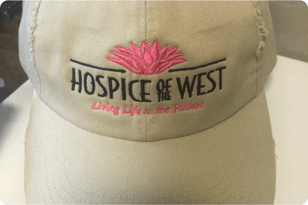 Hospice of the West branded hat saying Living Life to the Fullest